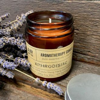 This natural, soy, organic, wax candle is called 'Aphrodisiac' and is ylang ylang and patchouli scented. In a bronze glass jar it fits any location and lasts up to 40 hours burn time.
