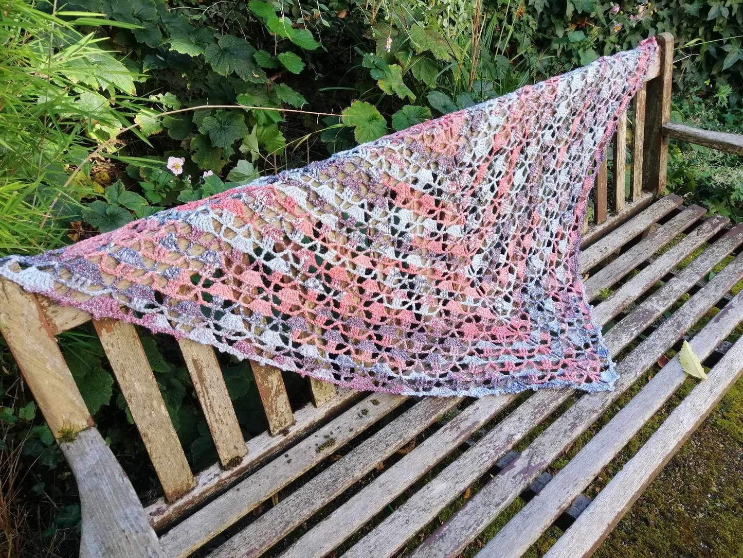 Our handmade 'Maryland Crochet Shawl' is seen here draped on a bench to show off it's full length and design.