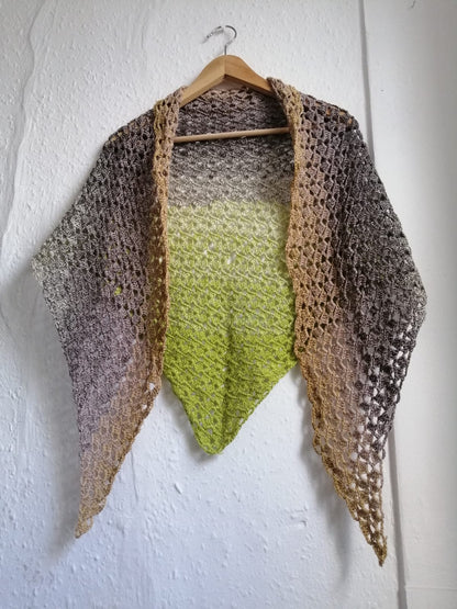 A handcrafted crochet shawl in shades of light green to light and dark brown to beige. This is called 'Mossy Stone Crochet Shawl' and is available for UK delivery.