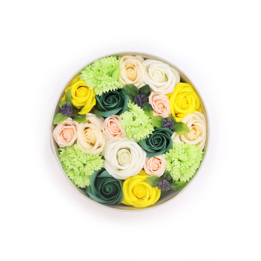 A round, hat box featuring soap Roses and Carnations in whites, pinks, yellows and greens. A perfect dose of scented Spring in a box.