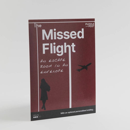 'The Missed Flight' is an escape room puzzle in an envelope, perfect to play with family and friends. The envelope is a maroon burgundy colour, with a black silhouette of a lady in the bottom left corner and an airplane in the middle right, the text is white. The instructions and information about the game are on the back of the pictured envelope.